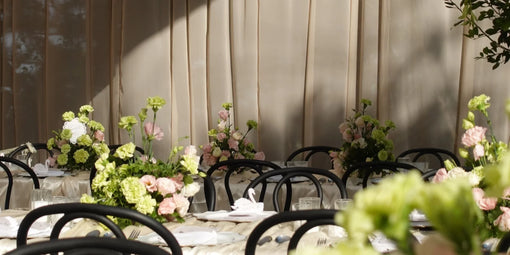 Outdoor garden wedding venue with soft draping and fresh flowers