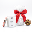Coffee Brew LUMI Scented Soy Candle (250ml) in a frosted glass jar with rose gold lid, styled beside its white Geami-wrapped bundle with red ribbon and gold pine cone for bulk holiday gifting.