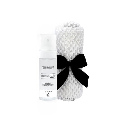 Fresh Bamboo LUMI Room and Linen Spray (50ml) bottle wrapped in a white woven textured cloth tied with a black ribbon bow
