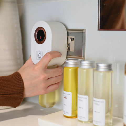 LUMI Plug-In Diffuser in White, plugged into a wall outlet