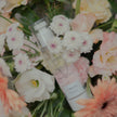 LUMI product surrounded by a bouquet of flowers