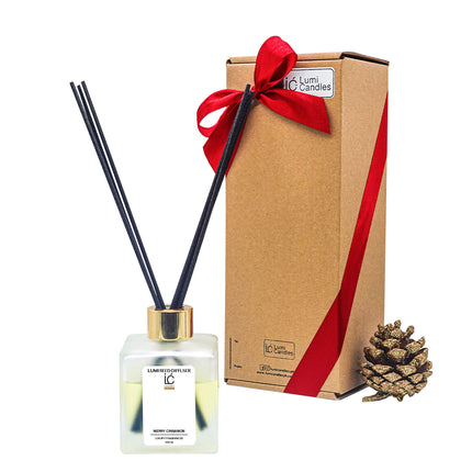 Merry Cinnamon LUMI Reed Diffuser bottle wrapped with a red ribbon for bulk gifting