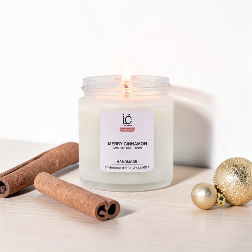 Merry Cinnamon Scented Soy Candle (100ml) lit with a glowing flame