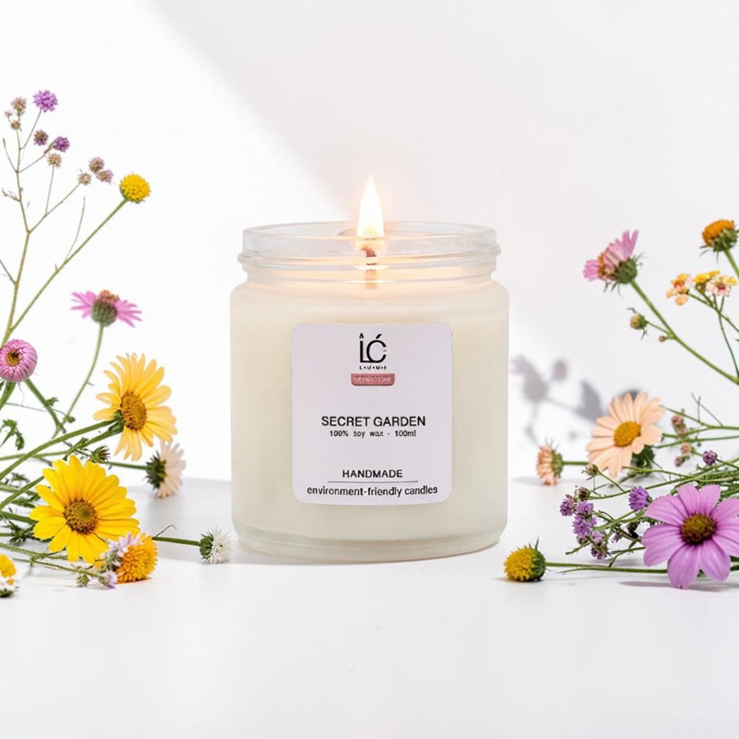 Secret Garden Scented Soy Candle (100ml) lit with a glowing flame